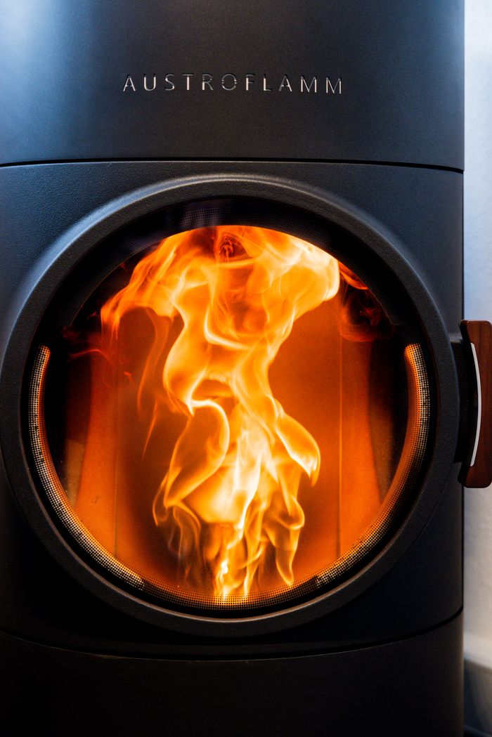 Vivid flames captured in an Austroflamm fireplace for a warm indoor ambiance.